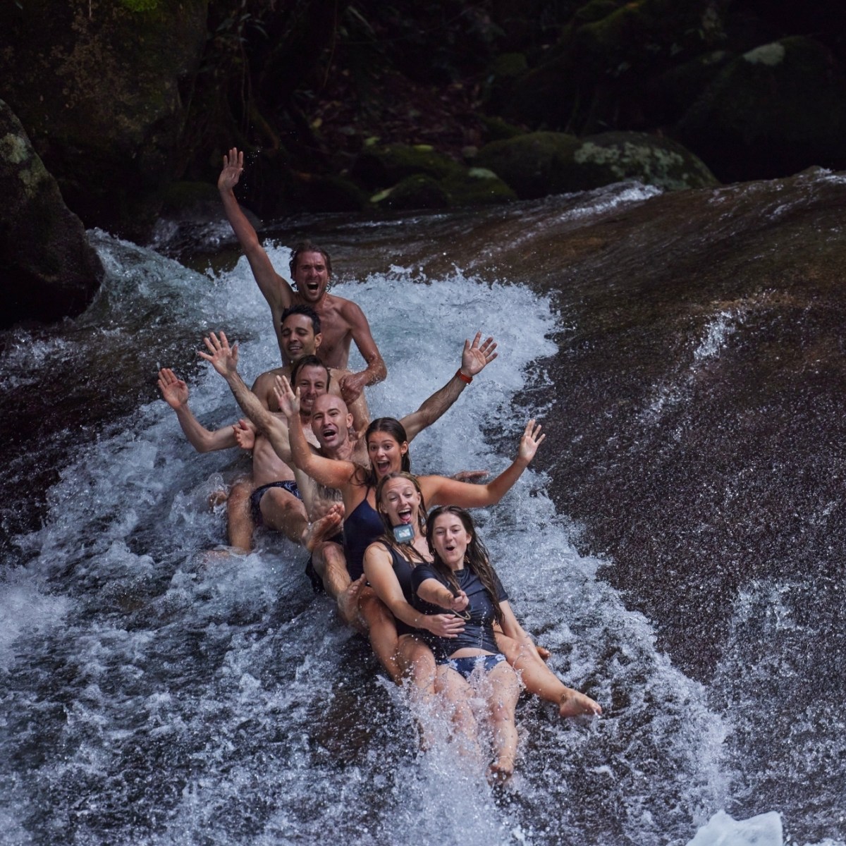 People having fun in the Natural Rock Slide Josephine Falls