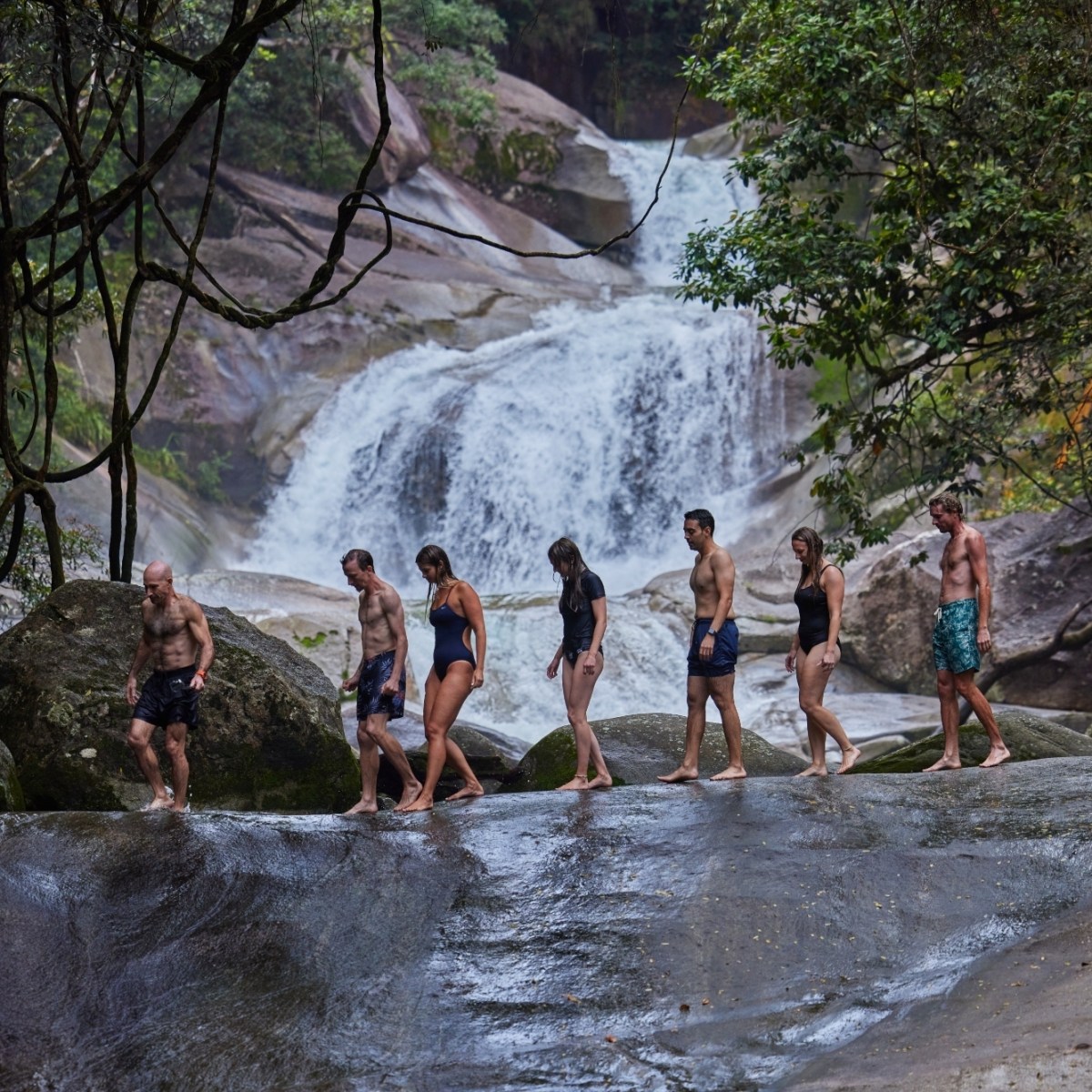 Group standing next to a Josephine Falls at day tour Cairns
