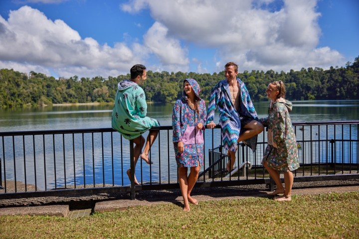 Group standing in front of a fence on a Lake Eacham day tour Cairns