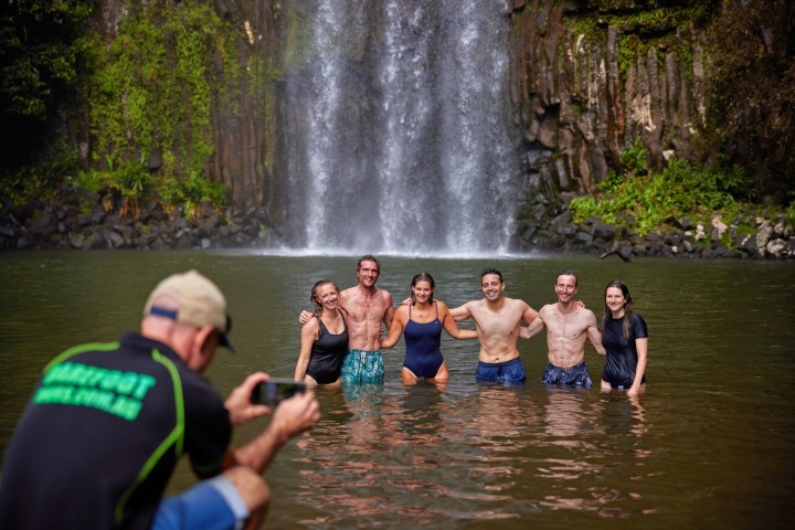 The group taking pictures in the water at Milla Milla Waterfalls