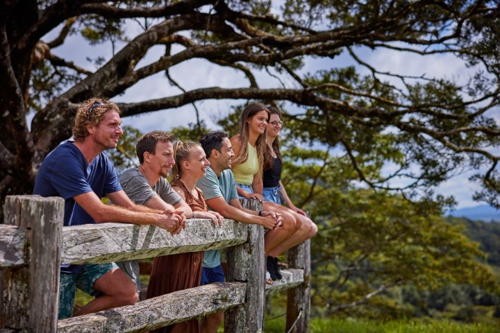 Group of people sitting on a wooden wall at Milla Milla Lookout