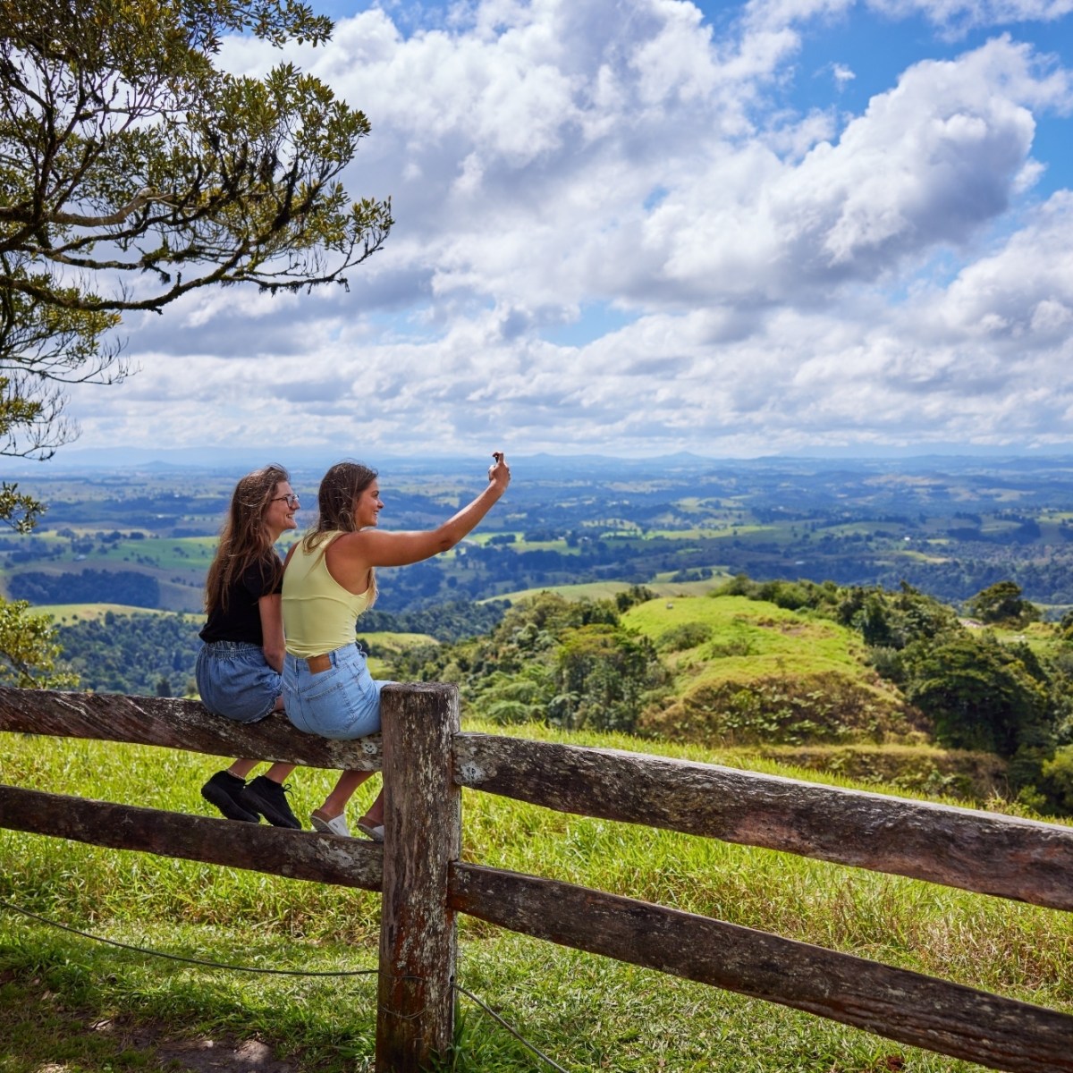 Two people sitting on a wooden fence at Milla Milla Lookout